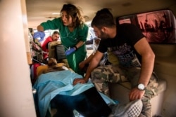 Syrian army soldiers wounded in fighting with Turkish and Turkish-backed forces are evacuated to a hospital from a frontline near the town of Tal Tamr, Syria, Nov. 9, 2019.