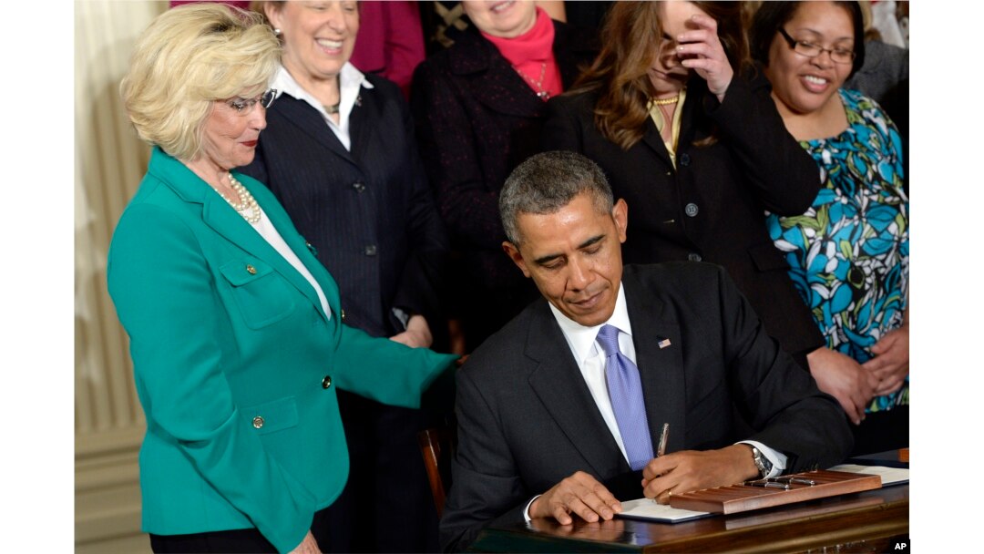 FILE - Lilly Ledbetter watches as President Barack Obama signs executive actions, with pending Senate legislation, aimed at closing a compensation gender gap that favors men, at the White House in Washington, April 8, 2014, during an event marking Equal Pay Day.