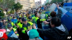 Demonstrators protesting against a China Taiwan trade pact clash with riot police clearing the government Cabinet buildings in Taipei, Taiwan, Monday, March 24, 2014.