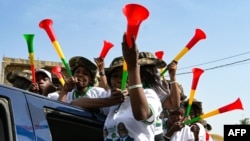 FILE —Supporters blow vuvuzelas as Senegalese presidential candidate Khalifa Sall (unseen) visits several districts of the capital as part of his political campaign for the 2024 presidential election, in Dakar, on March 9, 2024.