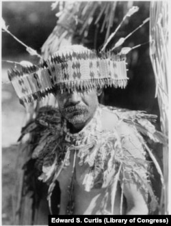 "Man in Pomo dance costume," 1924 photo by Edward S. Curtis. Koi Naiton tribe members are descended from the Southeastern Pomo people living on the island village of Koi in Clear Lake, California.