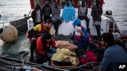 A migrant is prepared to be evacuated for medical reasons by helicopter from the Nuestra Madre de Loreto Spanish fishing vessel carrying 12 migrants rescued off the coast of Lybia, Nov. 30, 2018.
