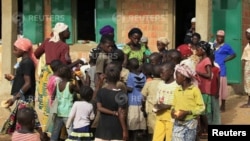 FILE - Children gather for breakfast at the Local Education primary school refugee centre Bondon, Kaura Local Government Kaduna State, March 20, 2014. 