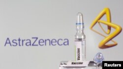 FILE - A test tube labeled "Vaccine" is seen in front of the AstraZeneca logo in this illustration photo taken Sept. 9, 2020. 