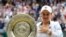 Australia's Ashleigh Barty poses with the trophy after winning the women's singles final, defeating the Czech Republic's Karolina Pliskova on day 12 of the Wimbledon Tennis Championships in London, July 10, 2021. 