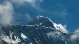 FILE - In this May 27, 2019, file photo, birds fly as Mount Everest is seen from Namche Bajar, Solukhumbu district, Nepal. 
