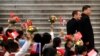 Le président français Emmanuel Macron, à gauche, et le président chinois Xi Jinping lors d'une cérémonie de bienvenue au Grand Palais du Peuple à Pékin, le 6 novembre 2019. Des écoliers agitent des drapeaux français et chinois