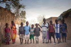 Sudanese refugees children pose for photographs, in the Treguine camp, in Hadjer Hadid, in the Ouaddaï region of eastern Chad, on March 24, 2019.