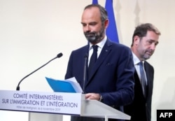 French Prime Minister Edouard Philippe, left, and French Minister of the Interior Christophe Castaner at a press conference at the Hotel Matignon in Paris, Nov. 6, 2019. Next year, France will start setting quotas on migrant labor.