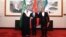 In this photo released by Xinhua News Agency, Ali Shamkhani, secretary of Iran's Supreme National Security Council, shakes hands with Saudi national security adviser Musaad bin Mohammed al-Aiban, as Wang Yi, China's most senior diplomat, looks on, March 11, 2023.
