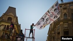 Egyptian 6th of April movement members protest against the renewal of the state of emergency during a demonstration in downtown Cairo, Sept. 16, 2013.