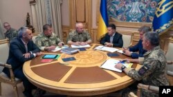 FILE - Ukrainian President Volodymyr Zelenskiy, third right, attends a meeting with Ukrainian top military officials in Kyiv, Ukraine, Aug. 7, 2019. (Ukrainian Presidential Press Office via AP)