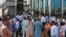 People stand outside their office building after a 6.2 earthquake is felt in Islamabad, Pakistan, Wednesday, May 9, 2018.