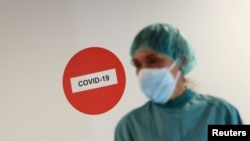 A hospital staff member is pictured before treating a patient suffering from COVID-19 at Hospital del Mar, where an additional ward has been opened to deal with an increase in coronavirus patients in Barcelona, Spain, July 15, 2021. 