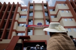 Una mujer mira la fachada de la Universidad Pública de El Alto, donde varios estudiantes murieron cuando un balcón se estrelló, tras el colapso de una barandilla, La Paz, Bolivia, el 3 de marzo de 2021.