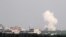 FILE - Smoke rises after an air strike in Saraqeb in Idlib province, Syria, Feb. 28, 2020. 