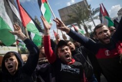 Palestinian protesters chant angry slogans during a protest against a new U.S. Mideast peace plan, in Gaza City, Jan. 28, 2020.