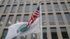 FILE - The flag of the Department of Education flies beneath the U.S. flag, at the Education Department building in Washington, April 3, 2018.