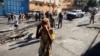 People walk on a street after civilians and members of the National Police clashed with gangs, in Port-au-Prince, Haiti, Feb. 23, 2025.