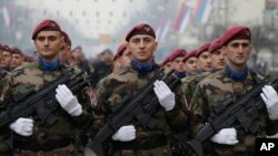 Members of the police forces of the Republika Srpska stand guard moments before a parade marking the 26th anniversary of the republic in the Bosnian town of Banja Luka, Jan. 9, 2018.