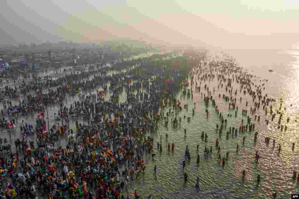 Hindu devotees gather to take a holy dip in the Bay of Bengal during the Gangasagar Mela, at Sagar Island, some 150 kilometers south of Kolkata, India.
