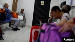 Kidney disease patients and their relatives wait at the waiting room of a dialysis center in Caracas, Venezuela, Feb. 6, 2018. 