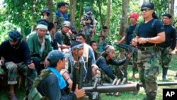 FILE - Undated photo of Abu Sayyaf spokesman Abu Sabaya, right foreground. Philippine troops captured an Abu Sayyaf rebel commander blamed for years of ransom kidnappings and on March 21, 2021 rescued the last of his four Indonesian captives.