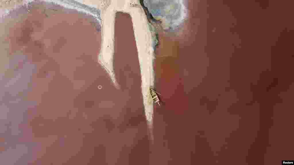 A view shows a boat at the edge of Lac Rose also known as Lake Retba in Niaga, near Dakar, Senegal, May 23, 2021.