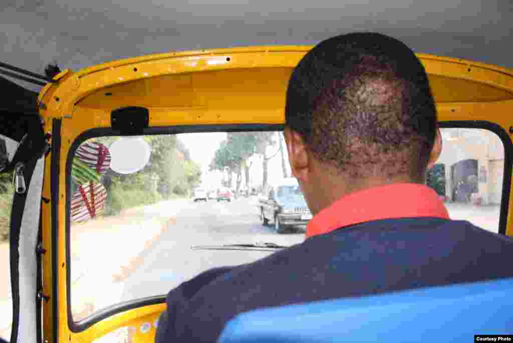 Bangi navigates the streets of Africa&rsquo;s commercial hub at a bracing maximum speed of 35 miles per hour, offering door-to-door service. (Photo by Darren Taylor)