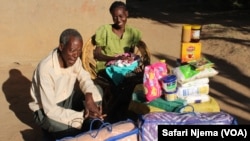 Lungisani and her father smile after receiving a donation of various goods.