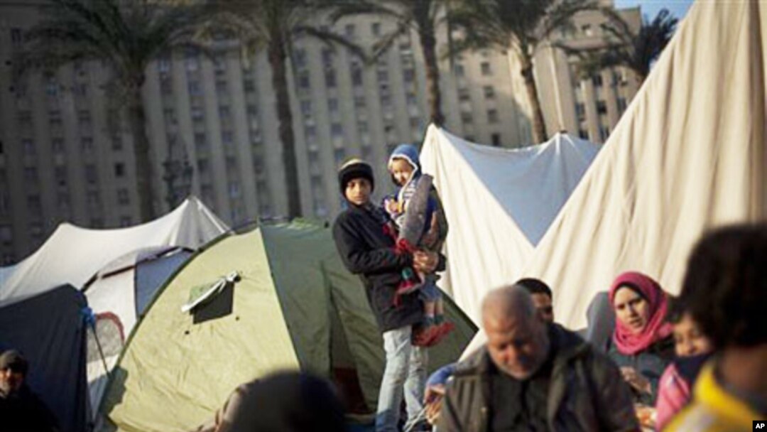 Egyptian anti-Mubarak protesters are seen next to their tents at Tahrir Square in Cairo, Egypt, Wednesday, February 9, 2011