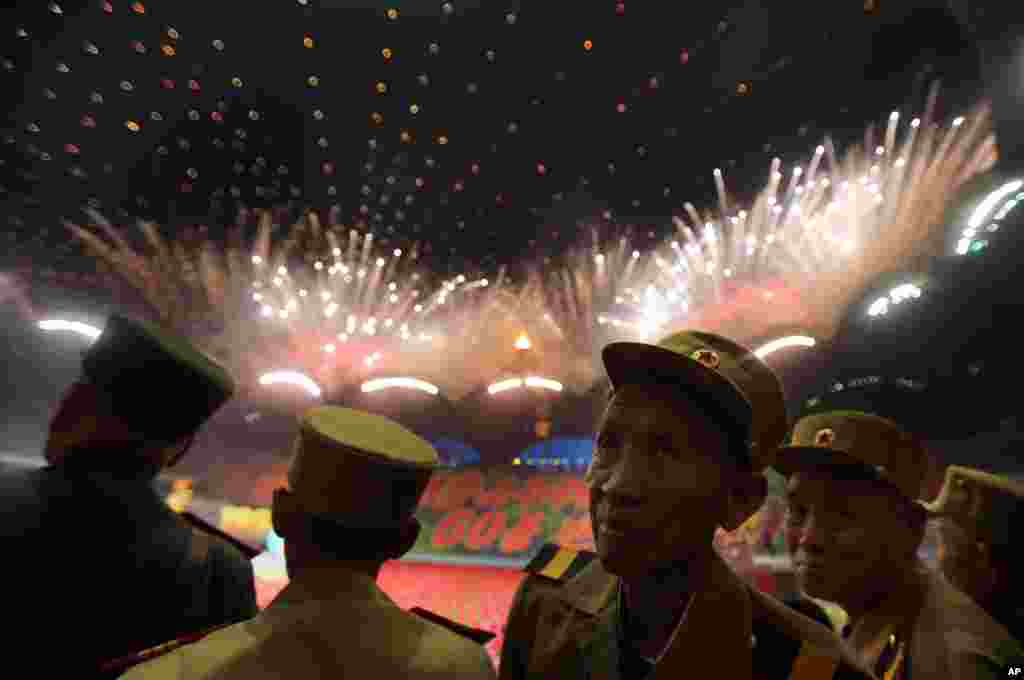 North Korean war veterans of the Korean War watch fireworks during the &quot;Arirang&quot; mass games song-and-dance ensemble on the eve of the 60th anniversary of the Korean War armistice in Pyongyang.