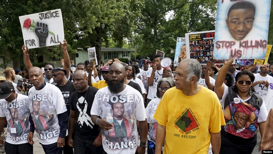 Michael Brown Sr., center, leads a memorial march for his son, Michael Brown, in Ferguson, Missouri, Aug. 8, 2015. 