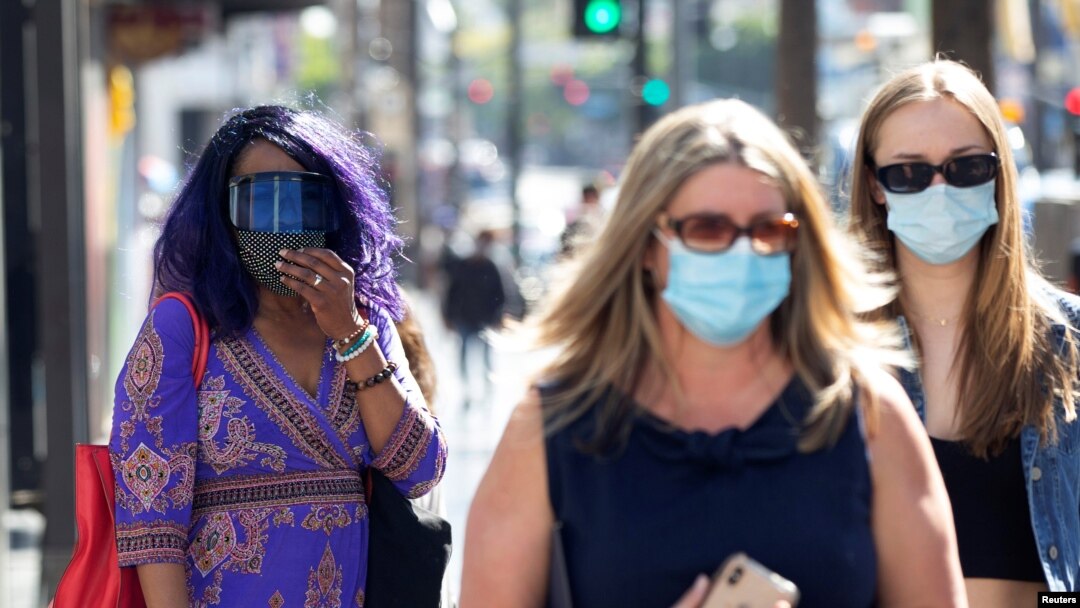 People wearing face protective masks walk on Hollywood Blvd during the outbreak of the coronavirus disease (COVID-19), in Los Angeles, California, U.S., March 29, 2021. 