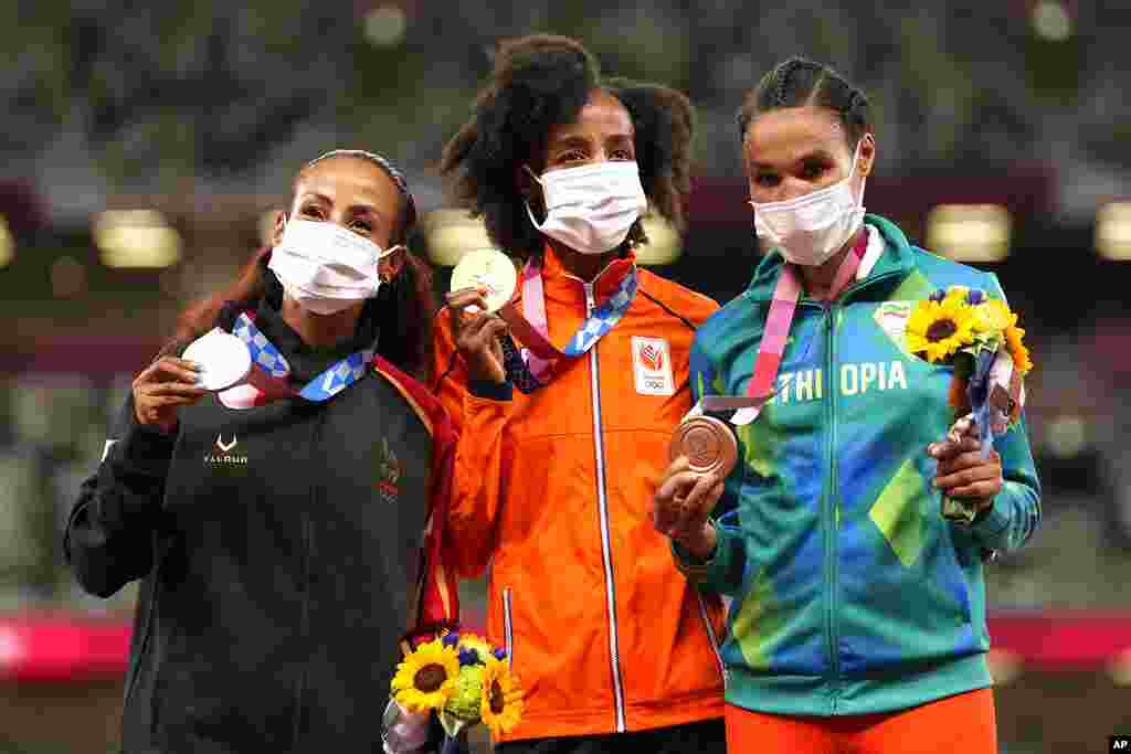 Gold medalist Sifan Hassan, of Netherlands, center, stands with silver medalist Kalkidan Gezahegne, of Bahrain, left, and bronze medalist Letesenbet Gidey, of Ethiopia, during the medal ceremony for the women&#39;s 10,000-meters at the 2020 Summer Olympics, Saturday, Aug. 7, 2021, in Tokyo. (AP Photo/Martin Meissner)