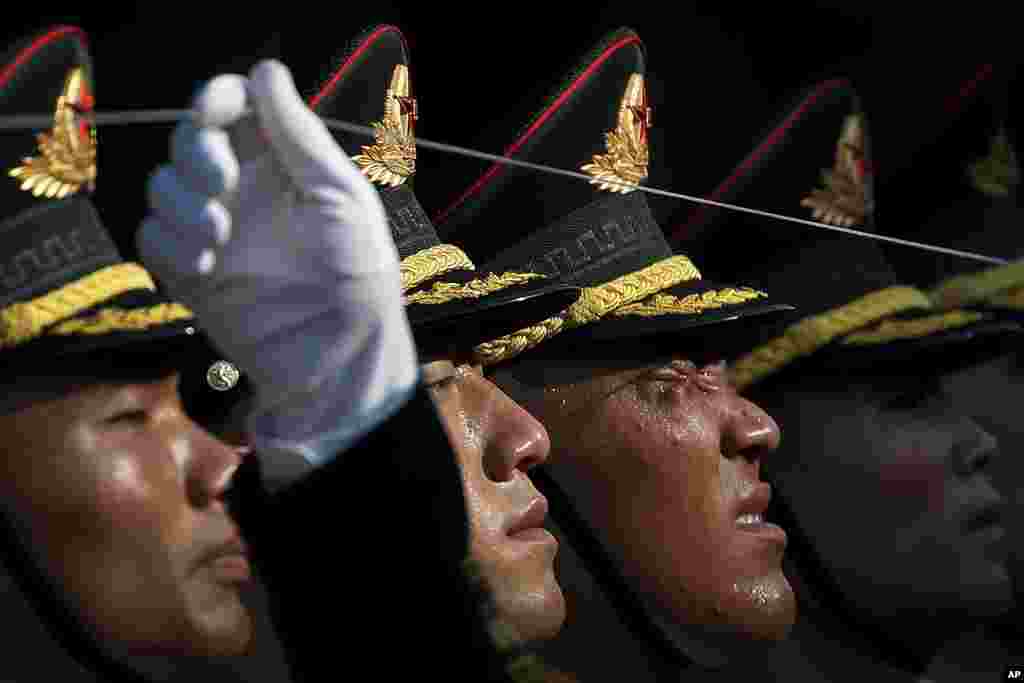 A member of an honor guard reacts as he and his comrades prepare for a welcome ceremony for visiting Colombia&#39;s President Ivan Duque, at the Great Hall of the People in Beijing, China.