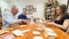 Jack Kloppenburg (left), professor in the Department of Community and Environmental Sociology, Irwin Goldman (center), chair of the Department of Horticulture, and Claire Luby (right), graduate student in the UW’s Plant Breeding and Plant Genetics program, fill envelopes with non-patented seeds in the Horticulture office in Moore Hall at the University of Wisconsin-Madison, April 11, 2014. 