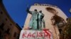A graffiti reading "racist" is seen on a statue of Fray Junipero Serra in Palma de Mallorca, Spain, June 22, 2020.