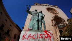 A graffiti reading "racist" is seen on a statue of Fray Junipero Serra in Palma de Mallorca, Spain, June 22, 2020.