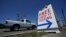 FILE - A pick-up truck passes a sign for free COVID-19 testing, in San Antonio, Texas, Aug. 14, 2020.