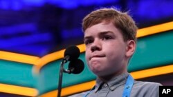 Anson Cook, 12, of Potomac, Md., reacts as he tries to spell his word as he competes in the finals of the Scripps National Spelling Bee in Oxon Hill, Md., May 30, 2019