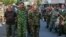 Armed pro-Russian separatists, right, escort a column of Ukrainian prisoners of war as they walk across central Donetsk, Ukraine, Aug. 24, 2014. 