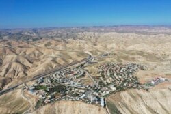 FILE - This Jan. 26, 2020, photo shows a view of the West Bank Jewish settlement of Mitzpe Yeriho. The United Nations Human Rights Council released a list of more than 100 companies it says are operating in Israel's West Bank settlements.