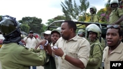 FILE - This photo taken on Jan. 5, 2011 shows Godbless Lema, a member of parliament for Arusha town, being arrested by an anti-riot police during a peaceful demonstration by supporters of the main opposition party Chadema. 
