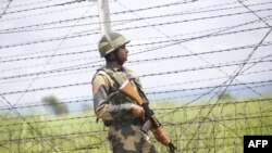 FILE - An Indian soldier patrols along the India-Pakistan border in Akhnoor near Jammu, Aug. 14, 2019. 