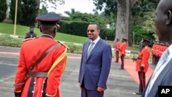 Ethiopia's new Prime Minister Abiy Ahmed, 42, who was installed in April, inspects the honor guard as he arrives to meet for bilateral talks with Uganda's President Yoweri Museveni at State House in Entebbe, Uganda, June 8, 2018. 