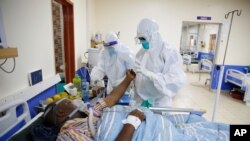 FILE — Medical staff wearing protective equipment attend to patients affected by COVID-19, on the Intensive Care Unit (ICU) of the Machakos County Level-5 hospital in Machakos, Kenya.