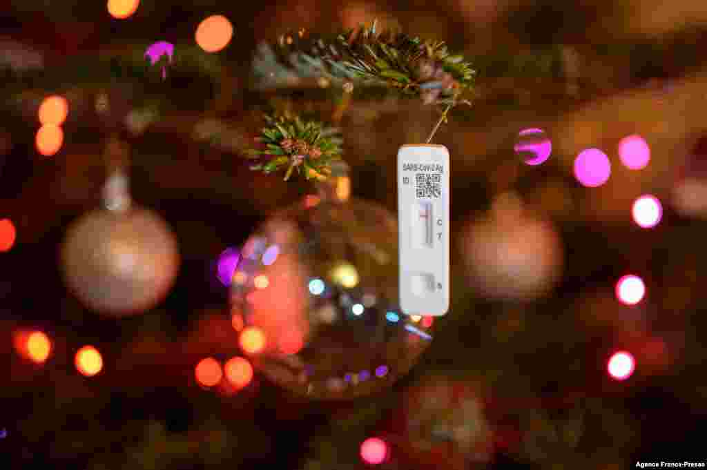 A negative SARS-CoV-2 rapid antigen test used to detect the Covid-19 coronavirus hangs on a Christmas tree in Lausanne, Switzerland..