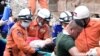 A rescue team carries a wounded worker at a collapsed building in Sihanoukville, Cambodia, June 22, 2019.