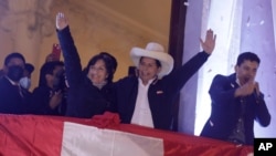 Pedro Castillo, center, celebrates with his running mate Dina Boluarte after being declared president-elect of Peru by election authorities, at his party´s campaign headquarters in Lima Peru, July 19, 2021. 